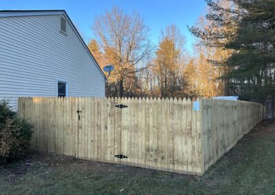 Classic wood fence installed by Fence Imperial, demonstrating elegant craftsmanship and natural beauty for enhancing property aesthetics.