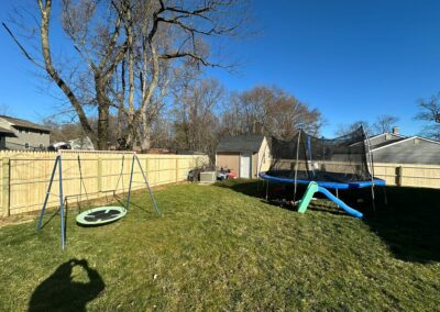 Classic wood fence installed by Fence Imperial, demonstrating elegant craftsmanship and natural beauty for enhancing property aesthetics.