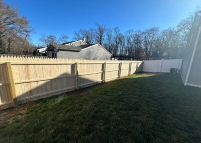 Classic wood fence installed by Fence Imperial, demonstrating elegant craftsmanship and natural beauty for enhancing property aesthetics.