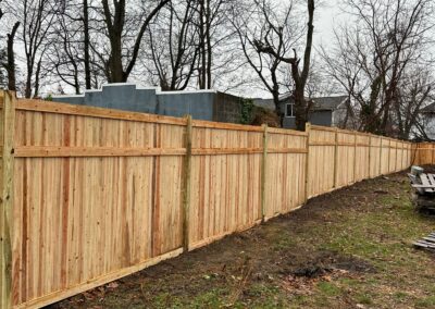 Classic wood fence installed by Fence Imperial, demonstrating elegant craftsmanship and natural beauty for enhancing property aesthetics.