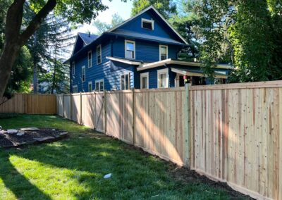 Classic wood fence installed by Fence Imperial, demonstrating elegant craftsmanship and natural beauty for enhancing property aesthetics.