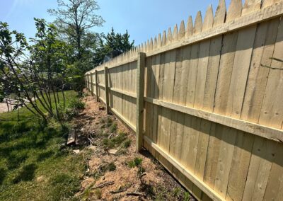 Classic wood fence installed by Fence Imperial, demonstrating elegant craftsmanship and natural beauty for enhancing property aesthetics.