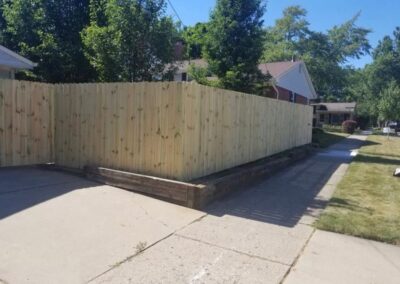 Classic wood fence installed by Fence Imperial, demonstrating elegant craftsmanship and natural beauty for enhancing property aesthetics.