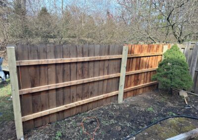 Classic wood fence installed by Fence Imperial, demonstrating elegant craftsmanship and natural beauty for enhancing property aesthetics.