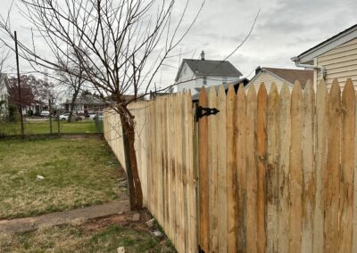 Classic wood fence installed by Fence Imperial, demonstrating elegant craftsmanship and natural beauty for enhancing property aesthetics.