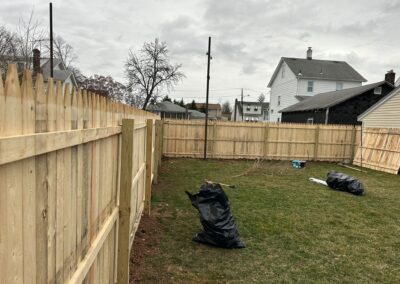 Classic wood fence installed by Fence Imperial, demonstrating elegant craftsmanship and natural beauty for enhancing property aesthetics.